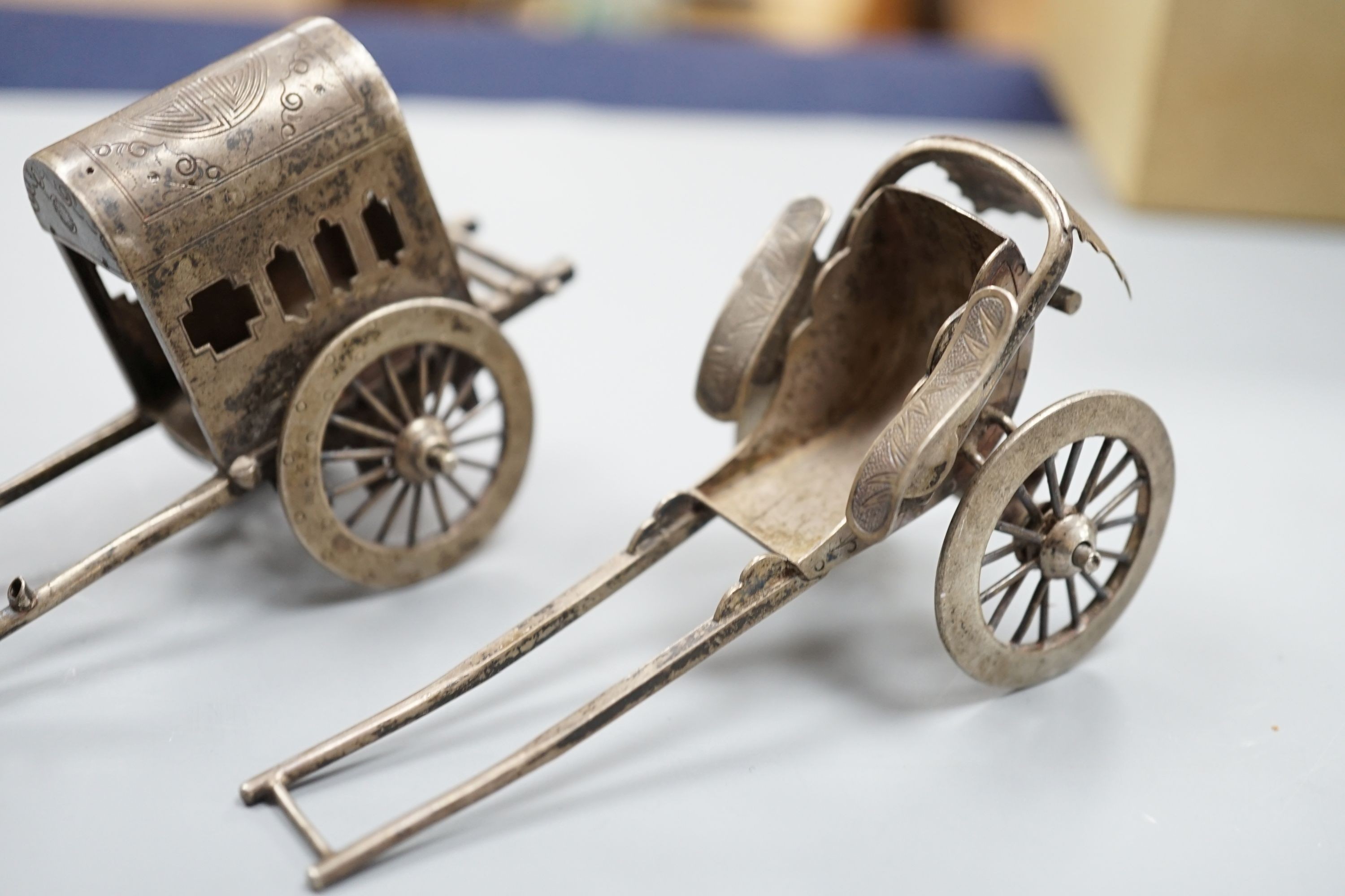 Two early 20th century miniature Chinese white metal models of a figure and rickshaw, by Wang Hing, length approx. 74mm. two other similar Chinese items and and unmarked miniature carriage.